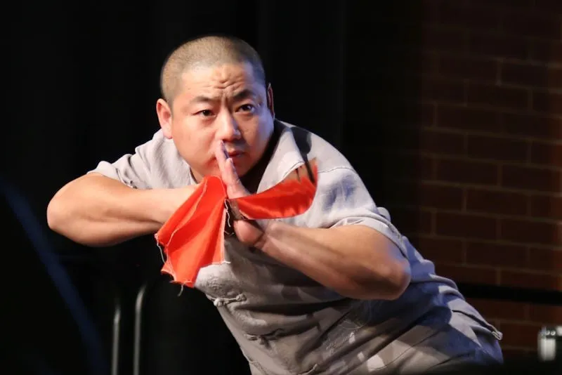 Shifu with performance sward looking very focused