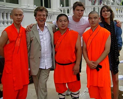 Three Sholin Monks including Shifu stand with Lionel Blair and E4 presenters