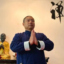 Portrait of Shifu Shi Heng Sheng, master of Shaolin Kung Fu and Tai Chi, in a traditional setting