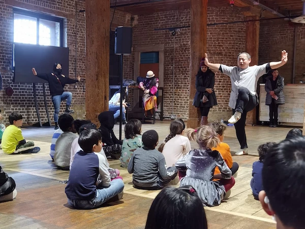 Shaolin master Shifu Shi Heng Sheng demonstrates a Kung Fu stance to students, focusing on balance and discipline